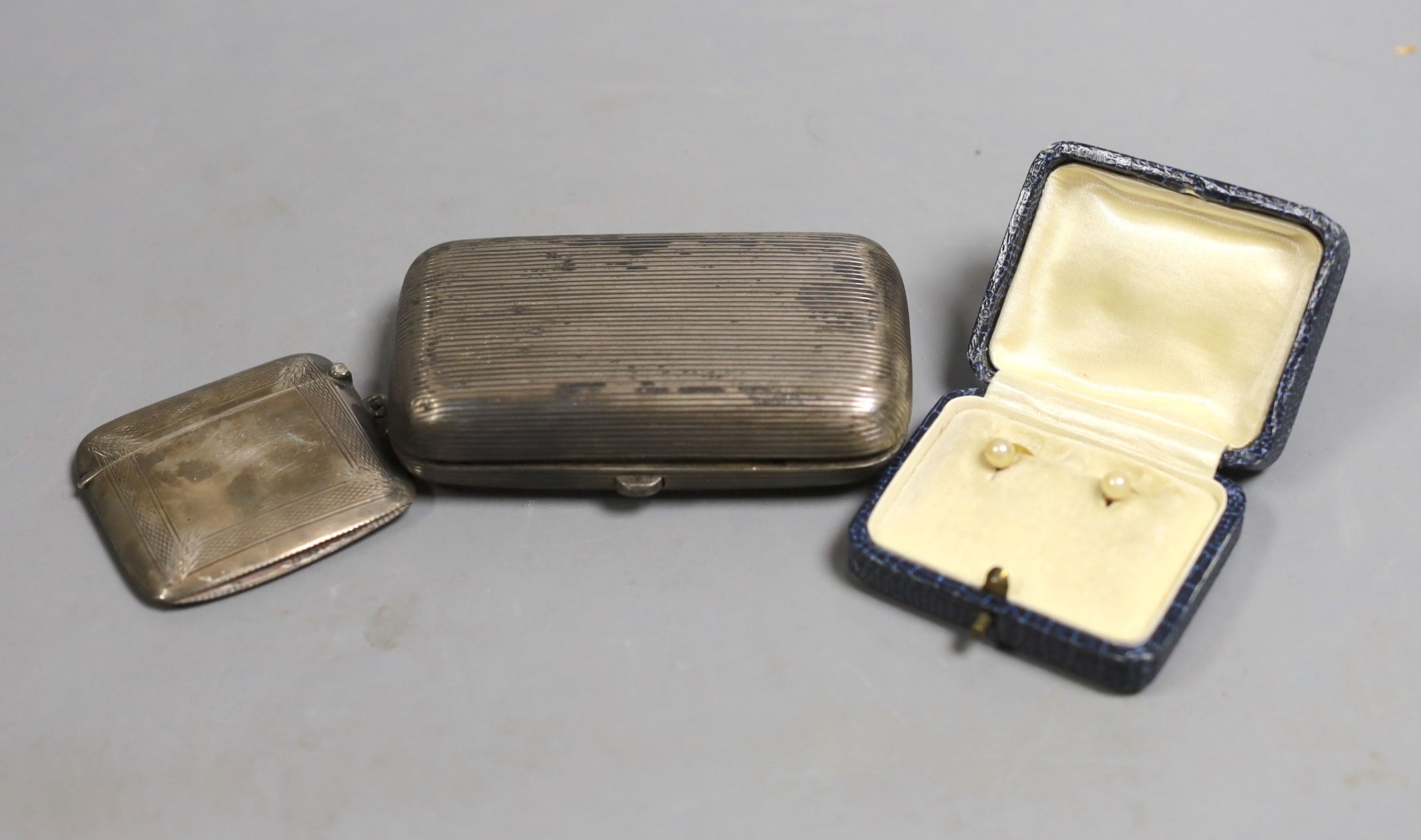 A late 19th century Russian 84 zolotnik cheroot case, 1892, 9cm, a silver vesta case and pair of 9ct and seed pearl dress studs, gross 1.7 grams.